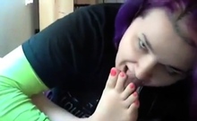 Goth emo girl licks her own feet